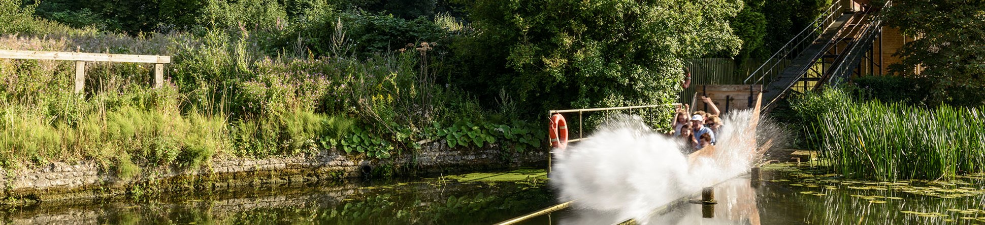 Water Chute at Wicksteed Park as a cart and its occupants hurtle into the water creating a huge splash.