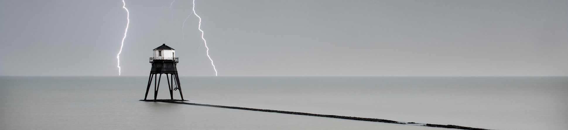 General view of the Dovercourt outer lighthouse with stormy sky and lightening