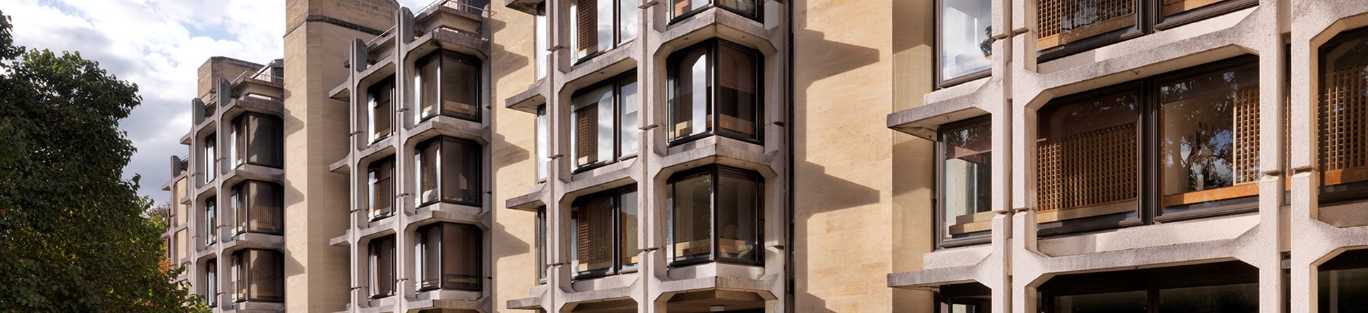 Colour photo of five storey building with external reinforced concrete skeleton.