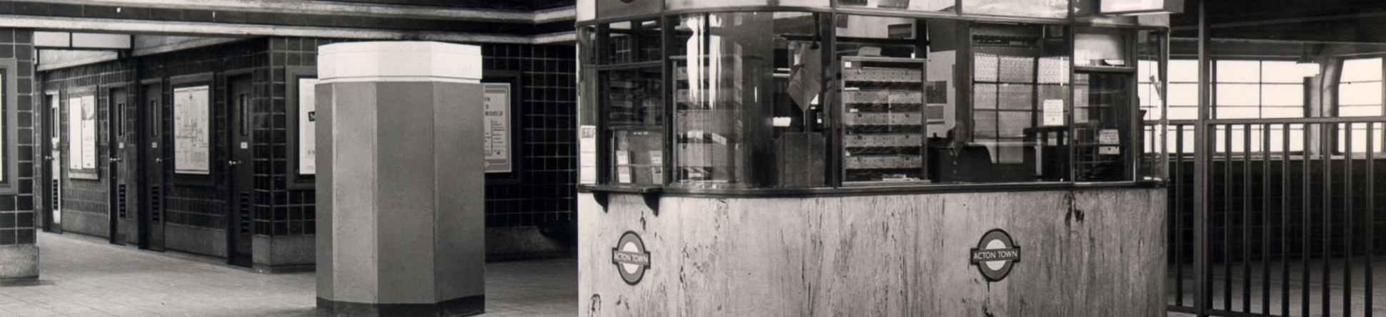 Black and white photo of Acton Town Underground Station ticket booth.