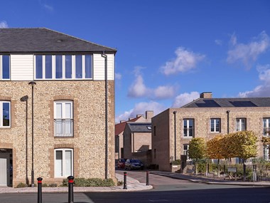 A group of modern three- and two-storey residential buildings with a mixture of brick, flint and weatherboard details.