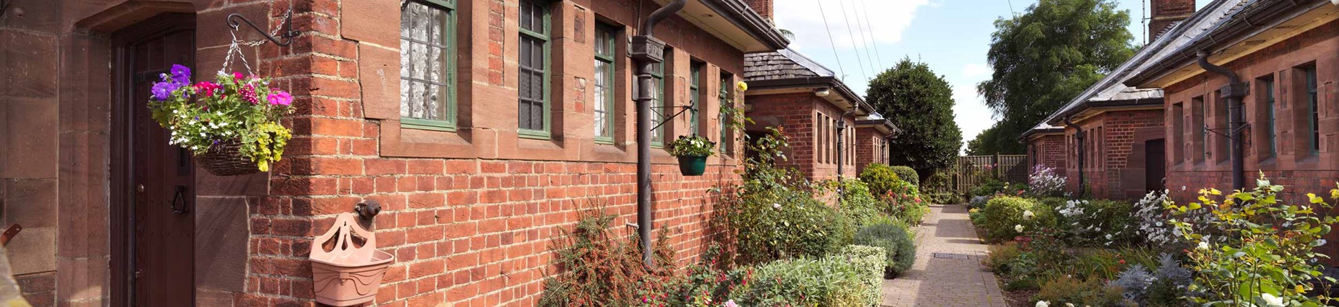 General view of almshouses and well-tended gardens.