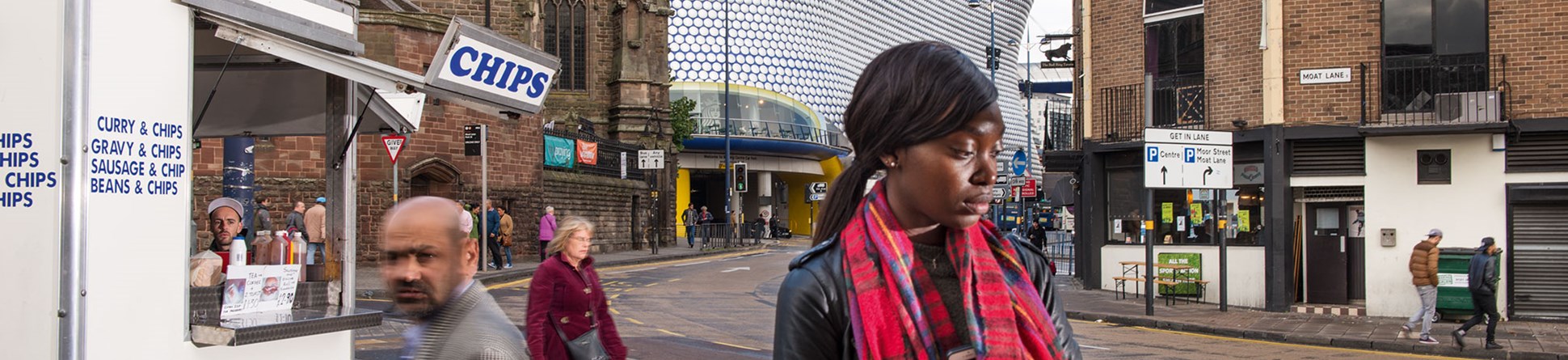 A market scene in Birmingham with a mixture of old and new building styles in the background.