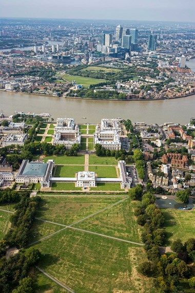 Aerial view of park with buildings and river beyond