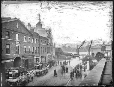 Old black and white photo of street life in London.