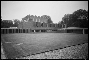 Black and white photo of Modernist student accommodation with grass lawn in foreground.